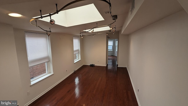 empty room with dark hardwood / wood-style flooring