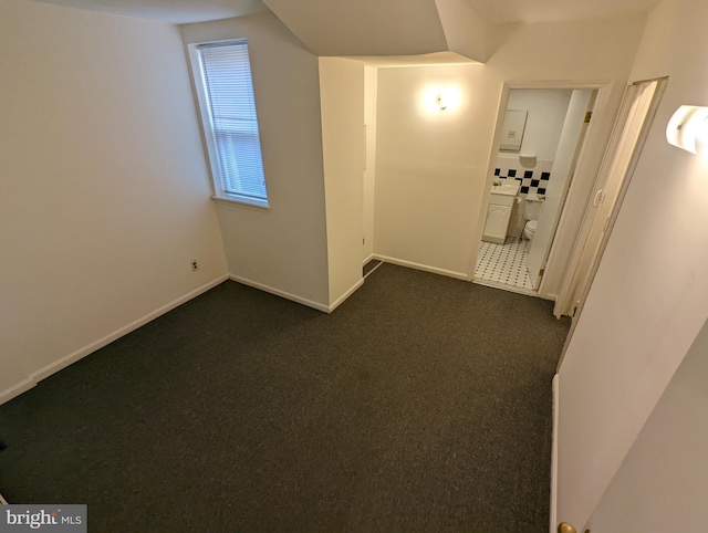 interior space featuring dark colored carpet