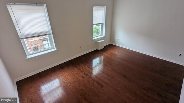 spare room featuring dark hardwood / wood-style flooring