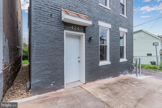 entrance to property featuring a patio area