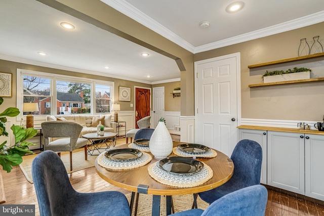 dining space with ornamental molding and dark hardwood / wood-style flooring