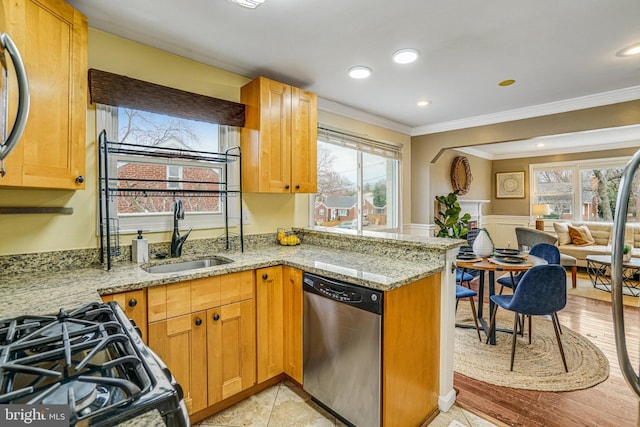 kitchen with sink, ornamental molding, light stone countertops, stainless steel dishwasher, and kitchen peninsula