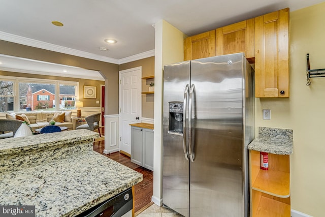 kitchen with ornamental molding, appliances with stainless steel finishes, and light stone countertops