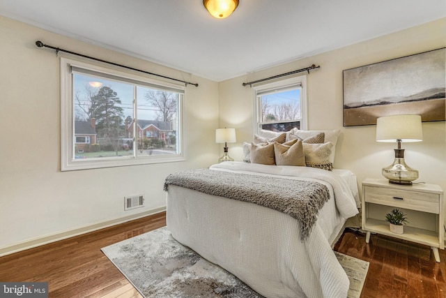 bedroom with dark hardwood / wood-style flooring