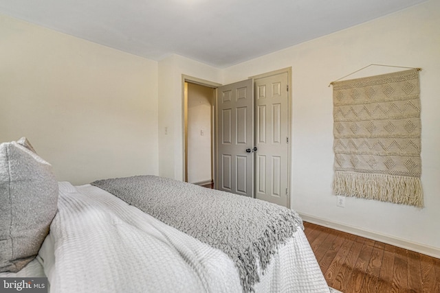 bedroom with wood-type flooring and a closet