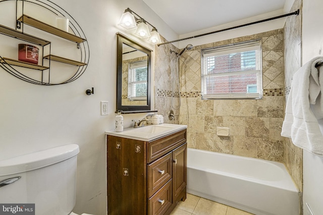 full bathroom featuring tiled shower / bath combo, vanity, tile patterned floors, and toilet