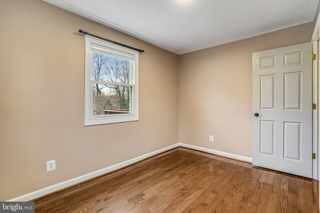 spare room featuring hardwood / wood-style floors