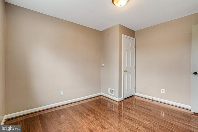 empty room with wood-type flooring