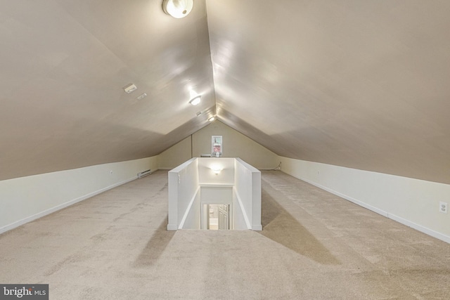 additional living space with lofted ceiling and light colored carpet