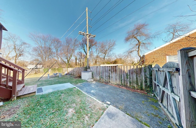 view of yard featuring a wooden deck and a patio area