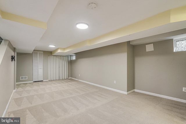 basement featuring light carpet