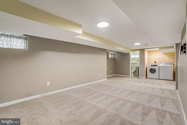 basement featuring light colored carpet and washing machine and clothes dryer