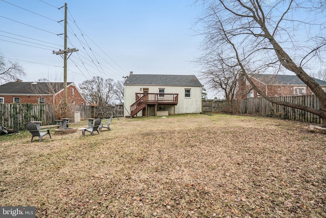 view of yard with a fire pit and a deck