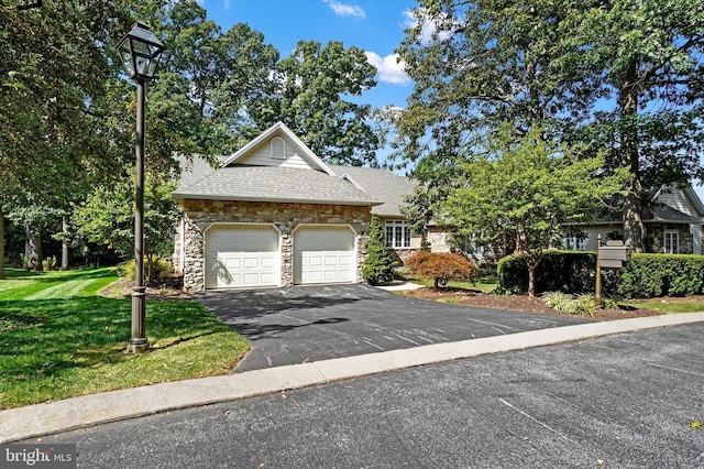 view of front of property with a front lawn and a garage