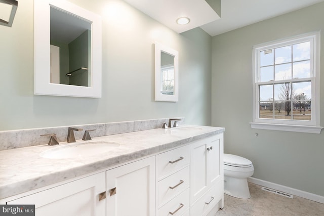 bathroom featuring vanity and toilet