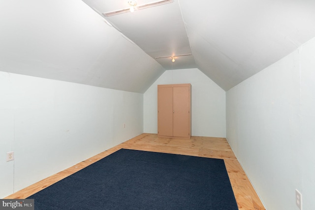 bonus room with lofted ceiling and hardwood / wood-style floors