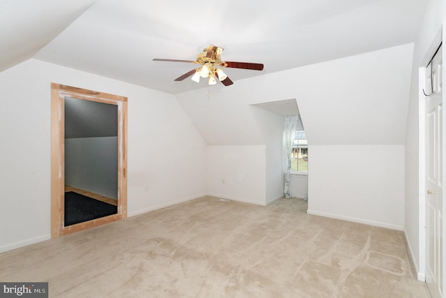 bonus room featuring lofted ceiling, light colored carpet, and ceiling fan