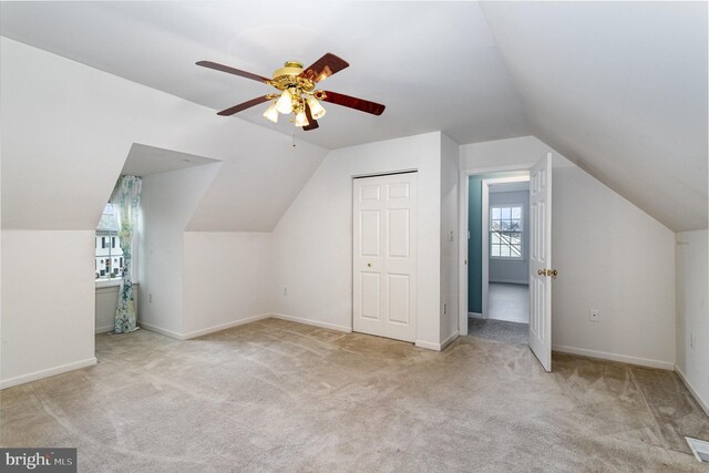 bonus room with ceiling fan, light colored carpet, and lofted ceiling