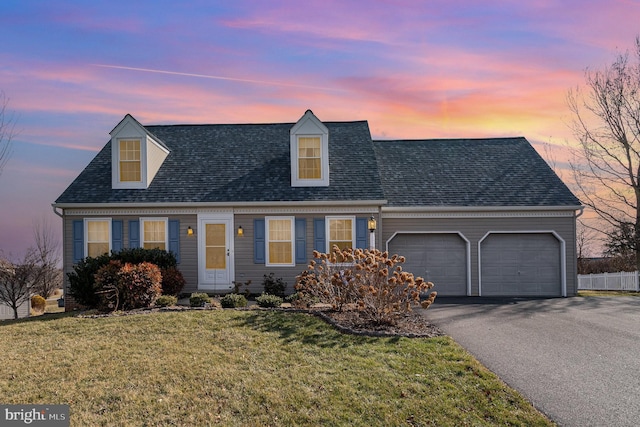 new england style home with a garage and a yard