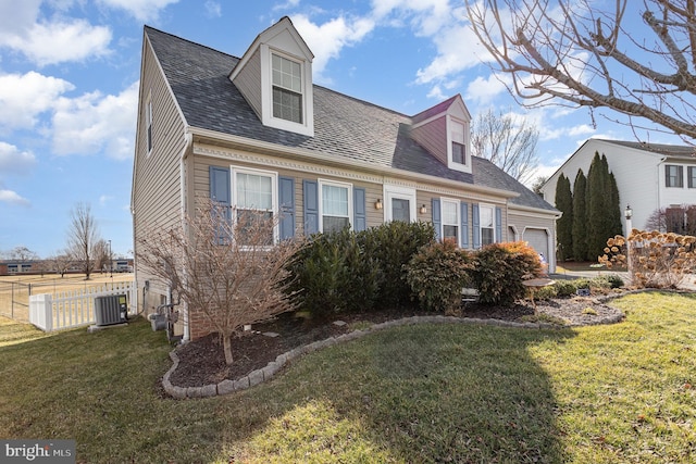 cape cod house featuring a garage, cooling unit, and a front lawn