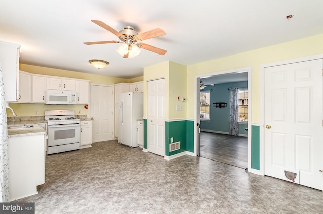 kitchen with ceiling fan, sink, white cabinets, and white appliances