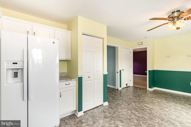 kitchen with white refrigerator with ice dispenser, white cabinets, and ceiling fan