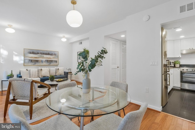 dining area with light wood-type flooring