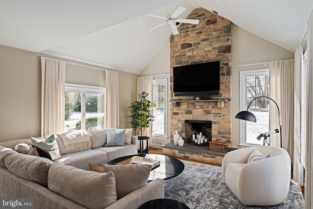 living room featuring hardwood / wood-style flooring, a fireplace, ceiling fan, and plenty of natural light