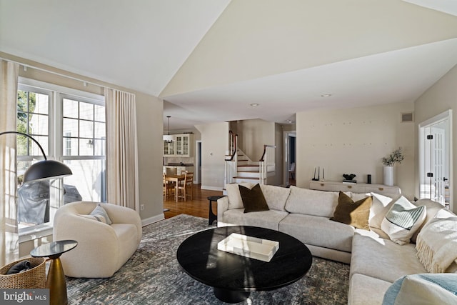 living room with hardwood / wood-style flooring and high vaulted ceiling