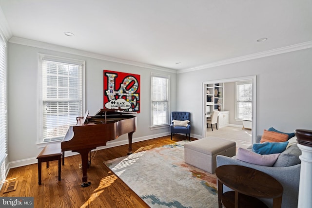 living area featuring ornamental molding and hardwood / wood-style floors