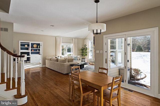 dining space with hardwood / wood-style flooring and lofted ceiling