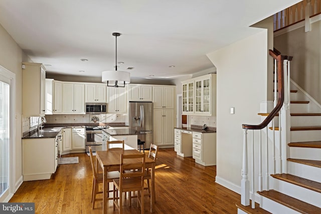 dining room featuring sink and light hardwood / wood-style flooring