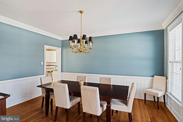 dining room with ornamental molding, dark hardwood / wood-style floors, and a notable chandelier