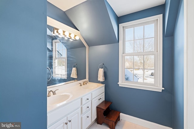 bathroom with vanity and vaulted ceiling