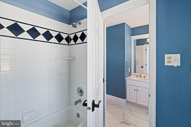 bathroom featuring tiled shower / bath and vanity