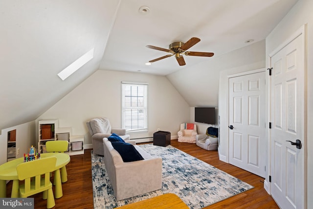 interior space with lofted ceiling with skylight, ceiling fan, dark hardwood / wood-style flooring, and baseboard heating