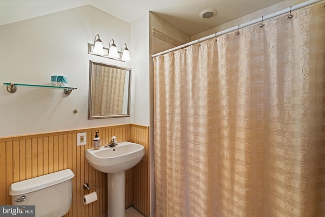 bathroom with wooden walls and sink