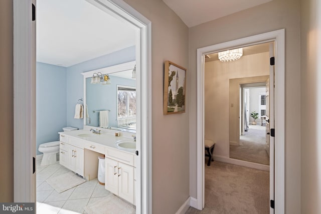 bathroom featuring tile patterned floors, vanity, and toilet