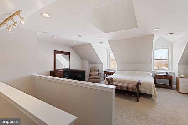 bedroom with light colored carpet and vaulted ceiling