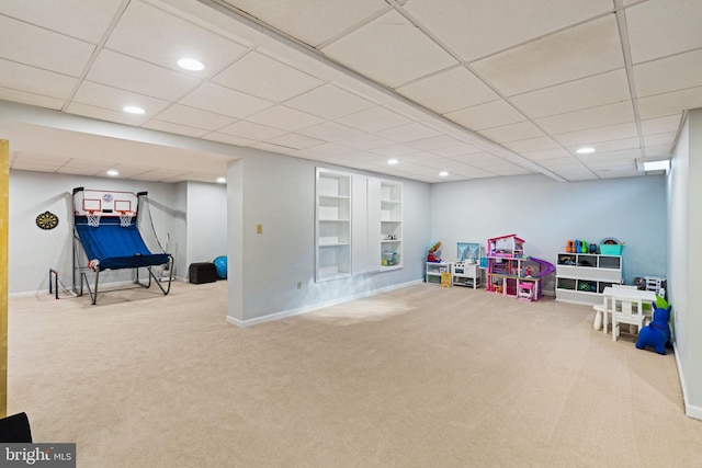 recreation room with carpet floors and built in shelves