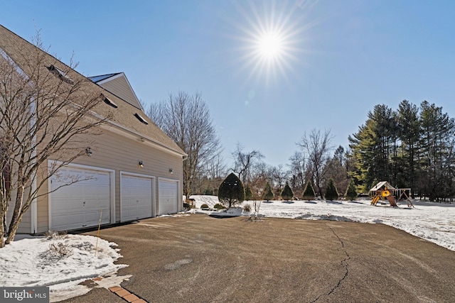 exterior space featuring a garage and a playground