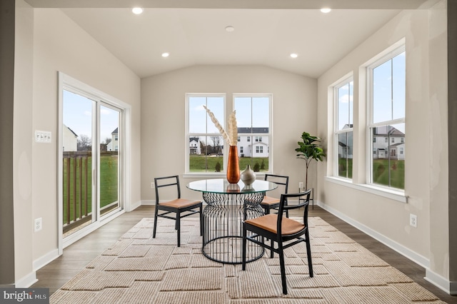 dining area with hardwood / wood-style floors and vaulted ceiling