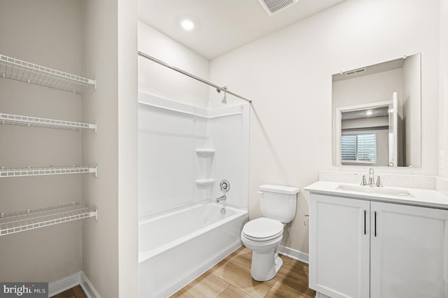 full bathroom with hardwood / wood-style floors, shower / bathing tub combination, vanity, and toilet