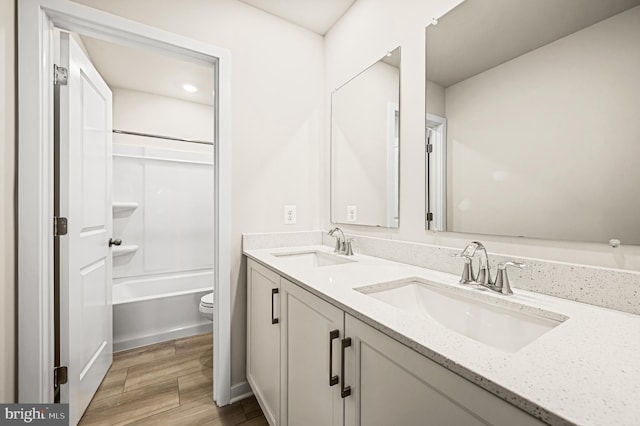 full bathroom with toilet, vanity, and shower / bath combination