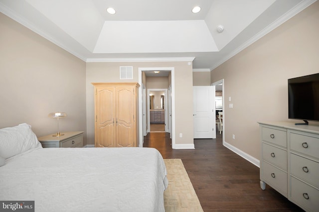 bedroom featuring a tray ceiling, dark wood-type flooring, visible vents, and baseboards