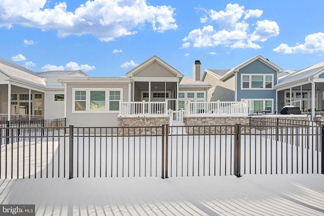 exterior space featuring covered porch and a fenced front yard