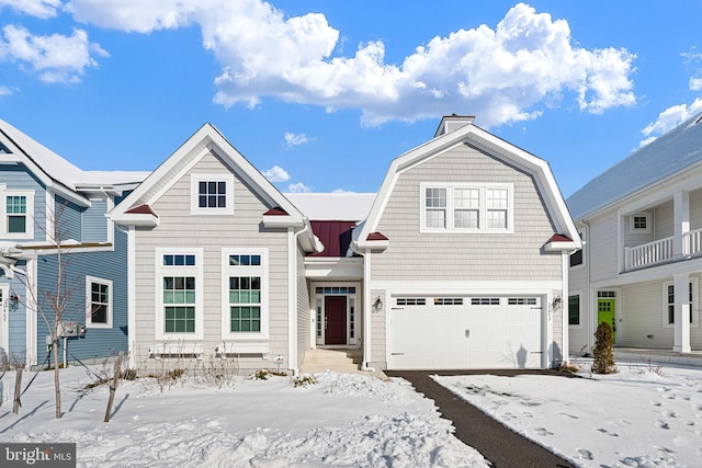 view of front of home featuring an attached garage, metal roof, and a gambrel roof