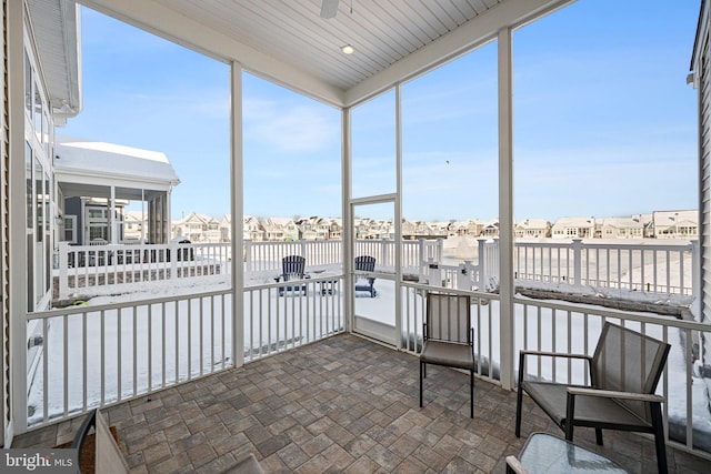 sunroom featuring a residential view