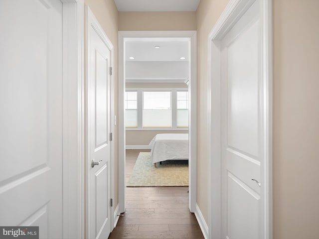 hall featuring baseboards and dark wood finished floors