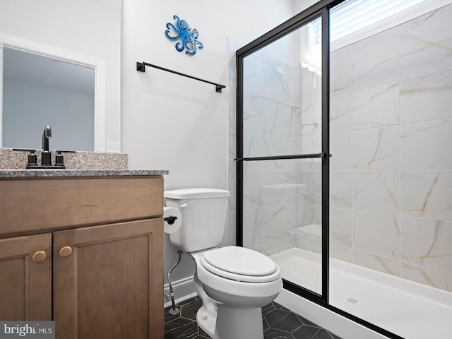 bathroom with toilet, a stall shower, and vanity